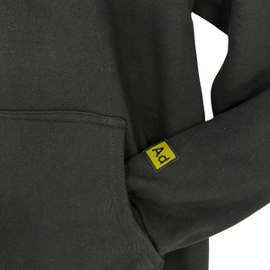 Close-up of the Adamantium BJJ black hoodie pocket with yellow logo tag detail.